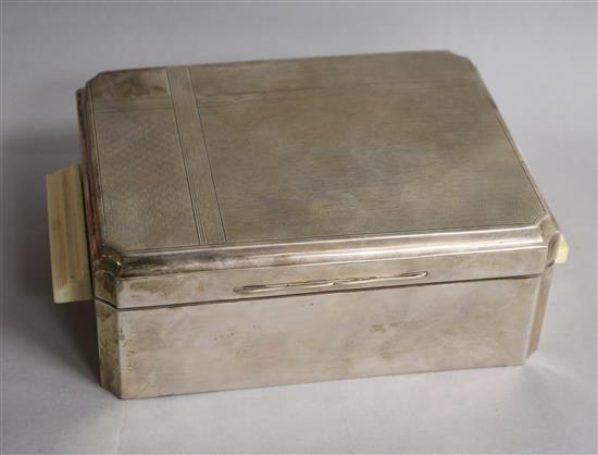 A George V Art Deco engine turned silver cigarette box, with ivory handles, James Dixon & Sons, Birmingham, 1934, 24.5cm